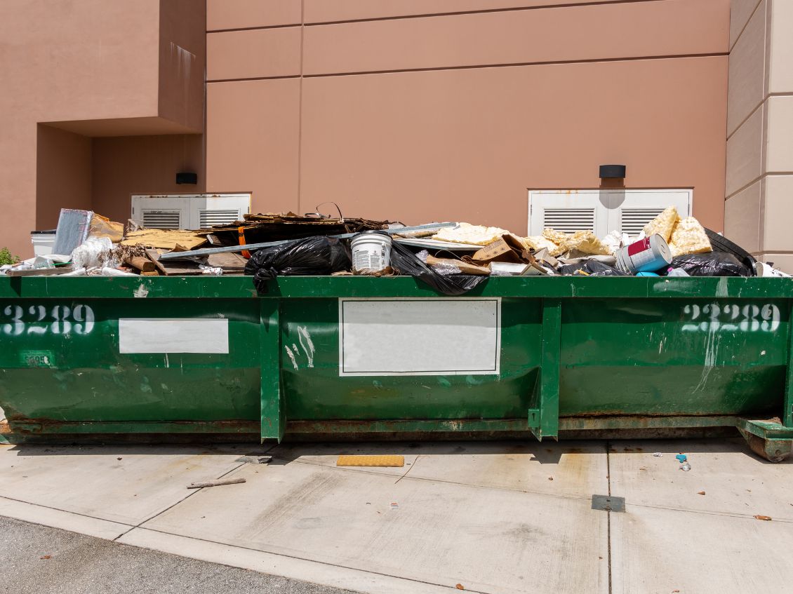 Overloaded dumpster, full garbage container, household garbage bin