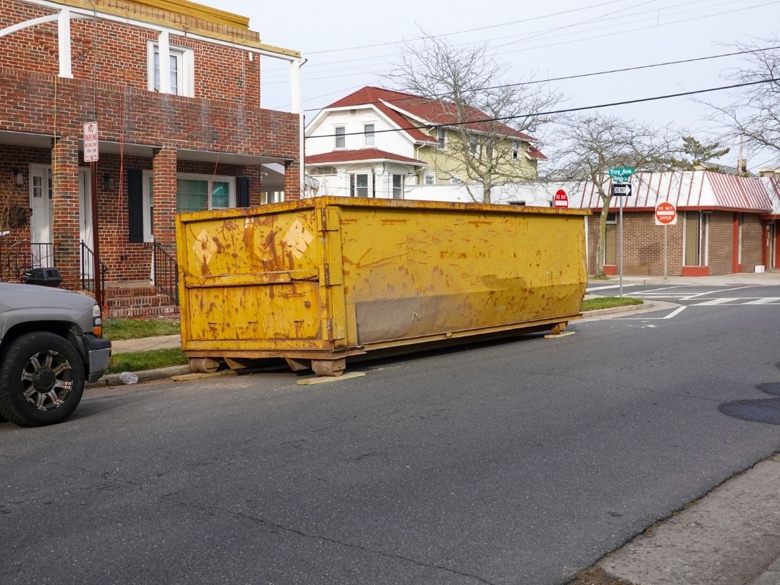 yellow dumpster on street