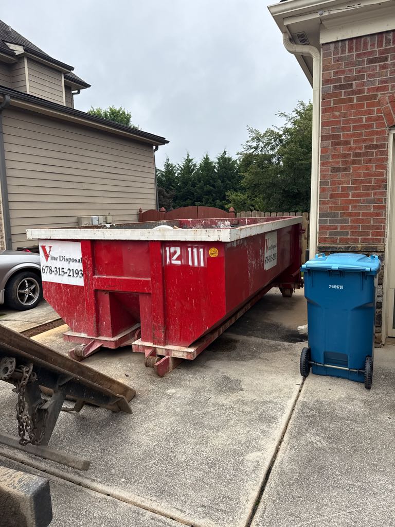 Vine Disposal roll-off dumpster delivered to a residential driveway in Auburn, GA