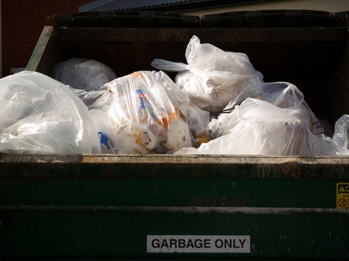 Overloaded dumpster, full garbage container, household garbage bin